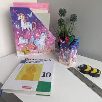 Application image of a pencil holder and a file organizer with a unicorn motif.