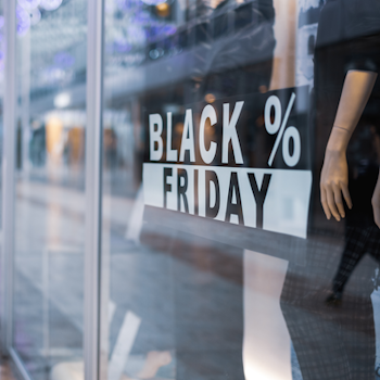 Display window with the sign 'BLACK FRIDAY' and a mannequin showcasing clothing.