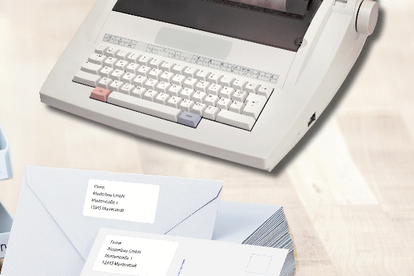 Envelopes with address labels and a typewriter