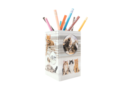 A pencil holder with pictures of cats and colorful pens sticking out.