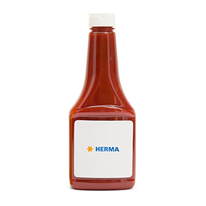 Bottle with red liquid, labelled with 'HERMA' on a white label.