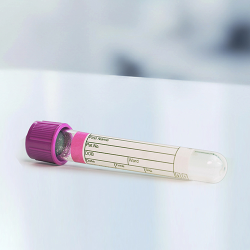A blood collection tube with a purple cap, labelled with space for patient information such as name and date of birth.
