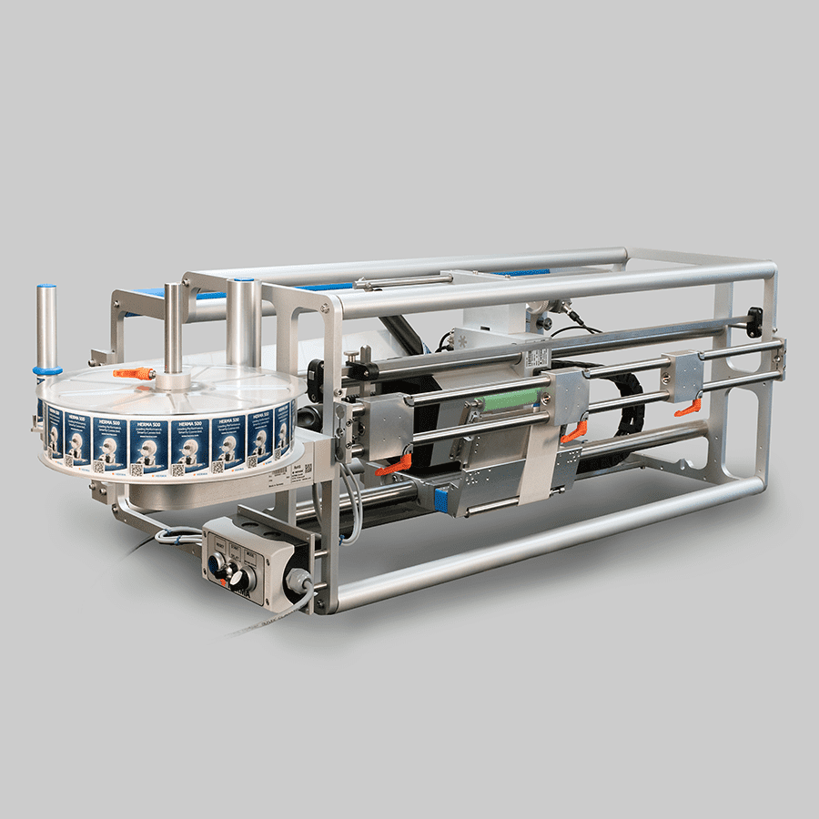 Labelling machine with a rotating disc and mechanical components, designed for industrial use.