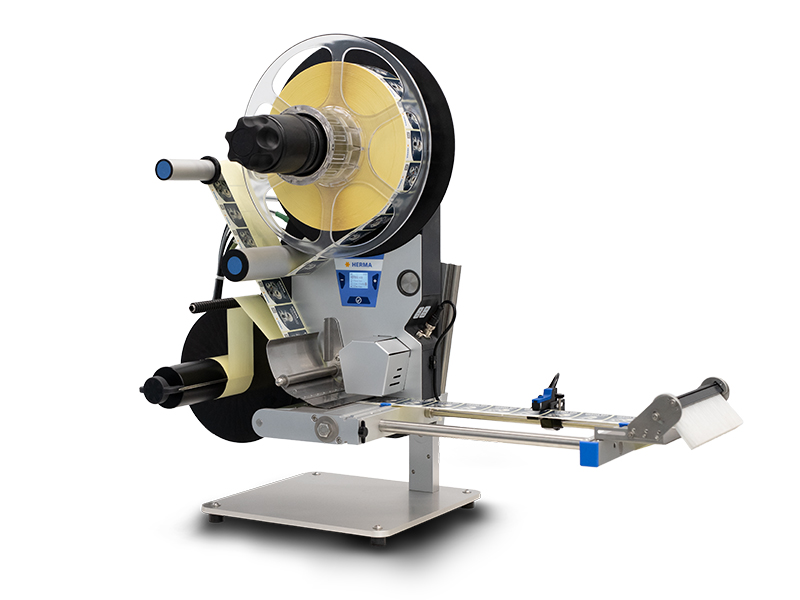 Labelling machine with rollers, a control panel, and a label dispensing mechanism. Ideal for industrial applications.