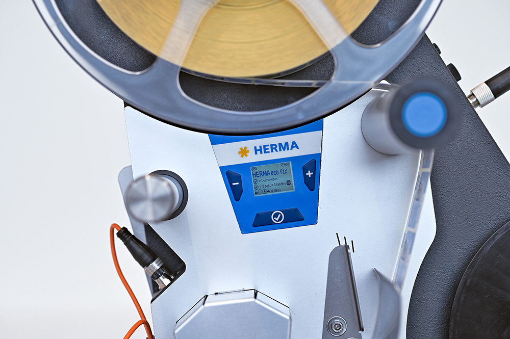 A labelling device with a digital display and a roll of labels. The controls are clearly visible.
