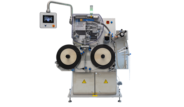 Machine with two large rollers, control unit, and various connections for processing materials.