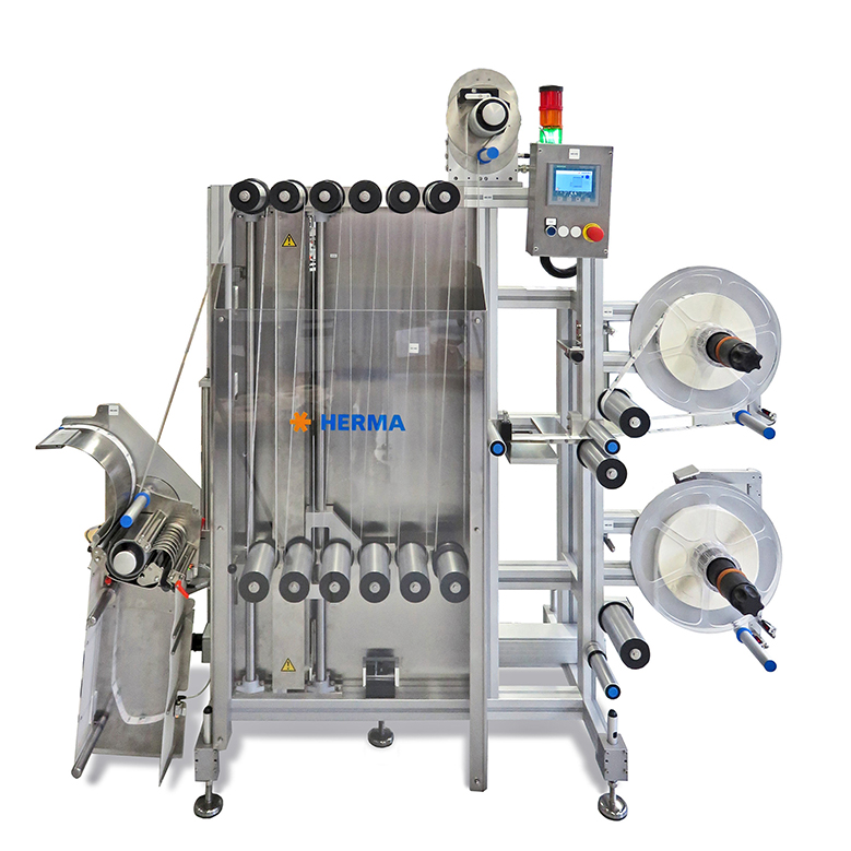 Automatic labelling machine with multiple rolls, control unit, and stainless steel frame. Ideal for industrial applications.