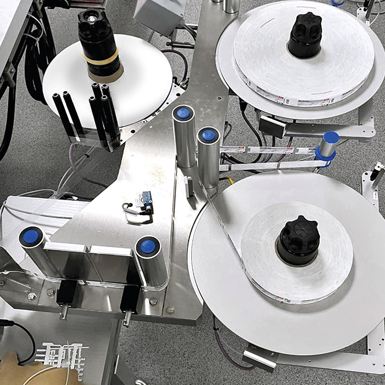 Machine with multiple spools and rollers used for processing or packaging materials.