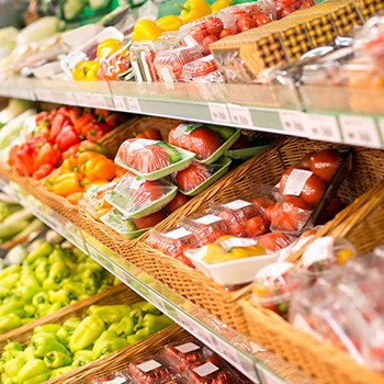 Labels with expiration dates and prices on food packaging on the shelf.