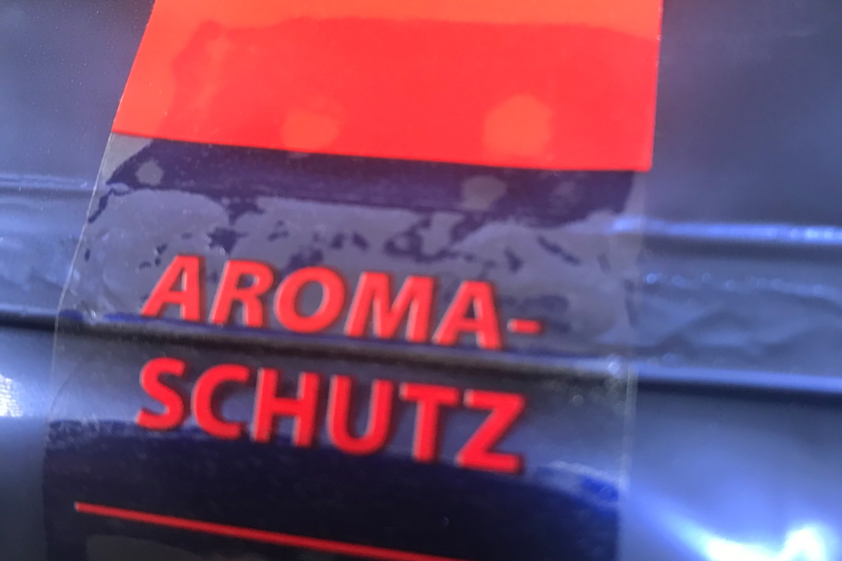 Closure labels: transparent resealable label, printed in color, on foil coffee packaging.