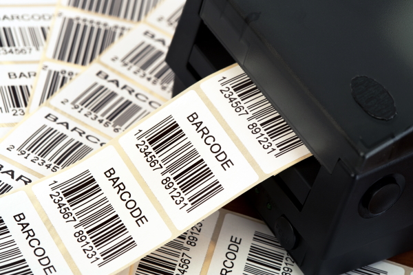Thermal labels on a roll, printed with barcodes.