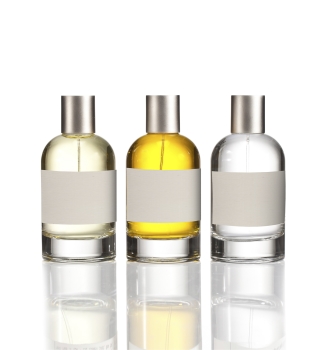 Three glass bottles containing different liquids: one clear, one yellow, and one light green. All have a silver cap and a blank label.