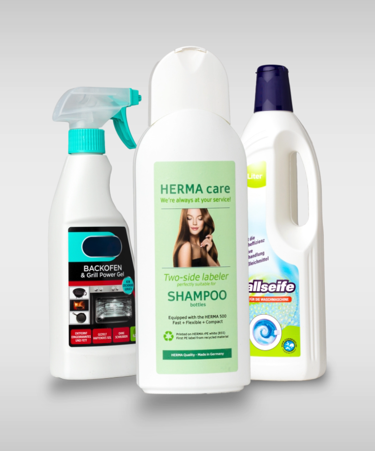 Three cleaning products: an oven spray, a shampoo bottle with dual labelling, and a bottle cleaner.