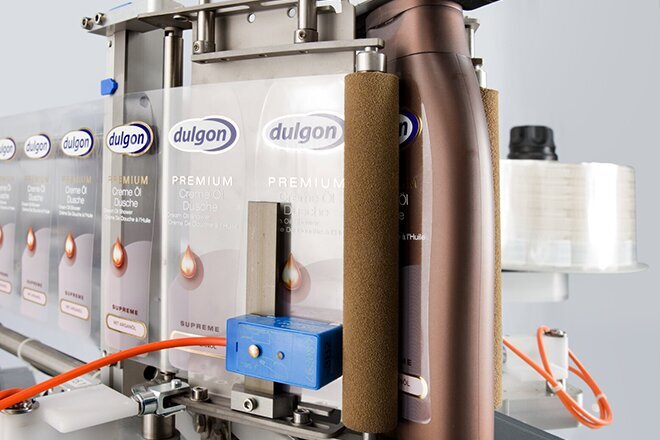 An industrial filling machine with multiple containers, used for filling liquids into bottles or cans.