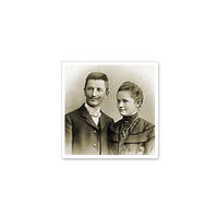 Two people in historical clothing, a man and a woman, are posing together against a neutral background.