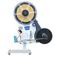 A labelling machine with a large spool and a black ribbon, equipped with a control panel and a sturdy base.