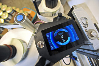 Control panel of a device with a digital display that shows the speed in RPM. The device components are visible.