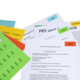 Various documents and notes with colorful sticky notes, including a production contract and a task list.