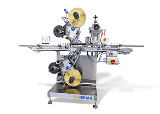 Automatic labelling machine with two labelling heads, equipped with rollers and control elements, mounted on a sturdy frame.