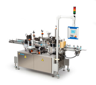 An automated labelling machine with multiple stations, control unit, and safety indicators.
