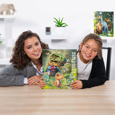 A woman and a girl are holding a book with dinosaur illustrations on a table. In the background, plants and decorations are visible.