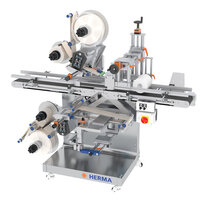 Automatic labelling machine with multiple label dispensers, equipped with control elements and a sturdy frame.