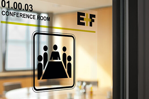 Transparent label on the glass door of a conference room.