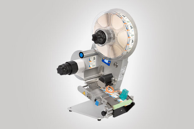 An industrial labelling machine with a large roller mechanism and multiple controls for customisation.