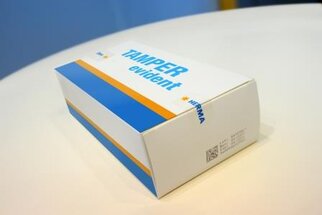 Packaging with the label 'TAMPER evident' in blue text on a white background, featuring an orange stripe.