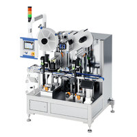 Automatic labelling machine with two rollers, control unit, and multiple bottles on a conveyor belt.