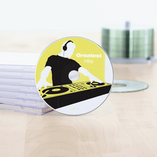 CD titled 'Greatest Hits' with a DJ design, surrounded by transparent CD cases on a table.