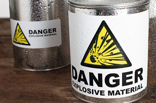 Label stickers on a can and on a glass pane in the rain.