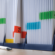 Binder with colored tabs and numbered labels that organize various documents. A pen is lying next to it.