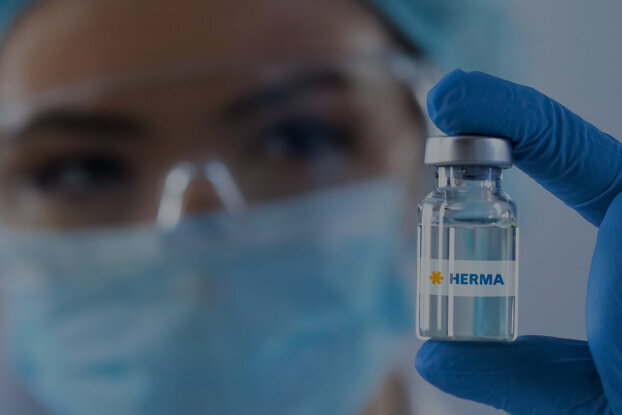 A person in protective gear is holding a vaccine vial labelled 'China'.