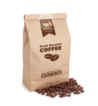Brown paper bag filled with fresh, roasted coffee, labelled '100% Premium Arabica Whole Beans' and surrounded by coffee beans.