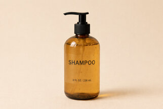 Brown shampoo bottle with a pump dispenser, labelled with 'SHAMPOO' and indicating a size of 8 FL OZ / 236 mL.