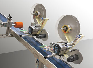 Two labelling machines on a conveyor belt applying labels to products.