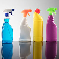 Row of cleaning product bottles in various colours: blue, orange, yellow, and purple, on a reflective surface.
