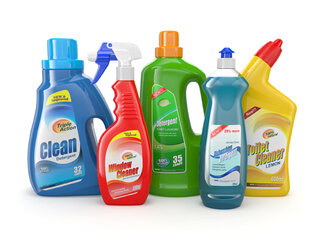 Six bottles of cleaning products in various colours and shapes, including window cleaner, all-purpose cleaner, and toilet cleaner.