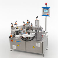 A labelling machine with multiple stations, equipped with cylinders and a control panel for operation.