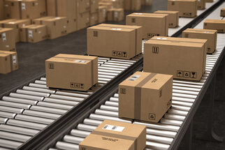 Cartons on a conveyor belt in a warehouse, ready for shipping. The packages are neatly arranged and labelled.